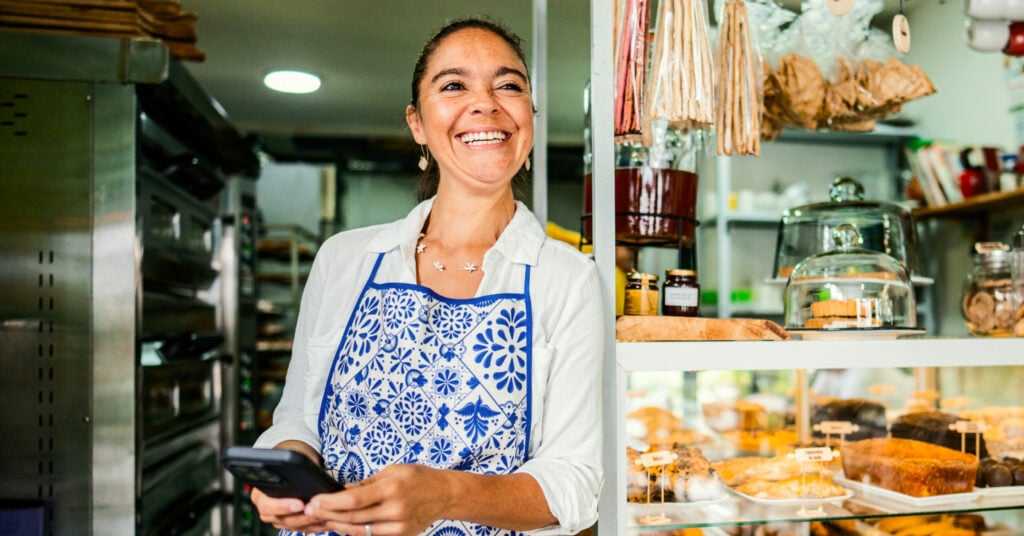 Sole trader posing infront of store with help of a Prospa Loan