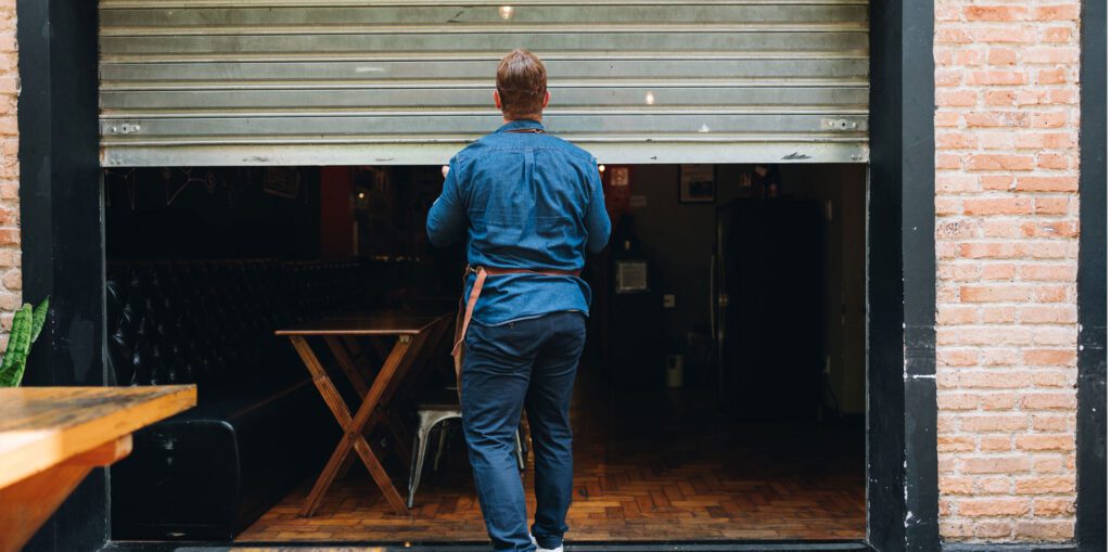 Business owner closing shutters