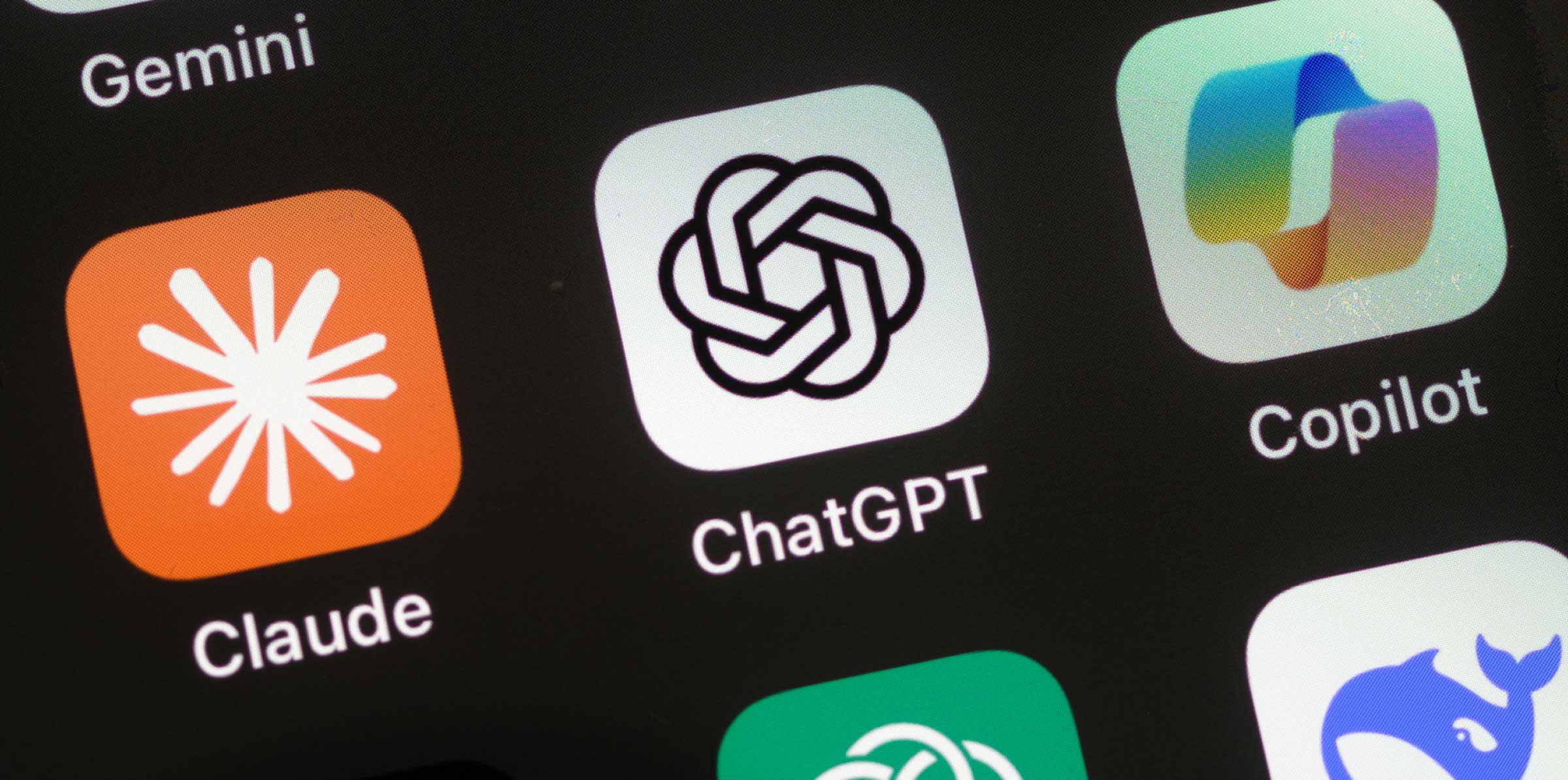 Close-up of smartphone screen displaying AI app icons including Gemini, Grok, Claude, and ChatGPT.