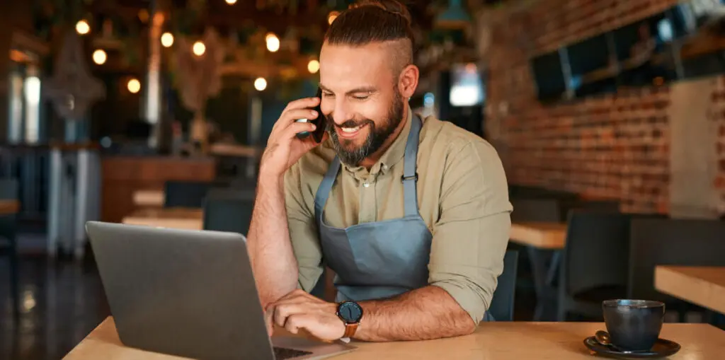 Business owner on the phone using a laptop